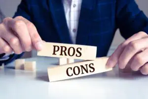 Defense attorney holding a wooden block with "Pros or Cons"