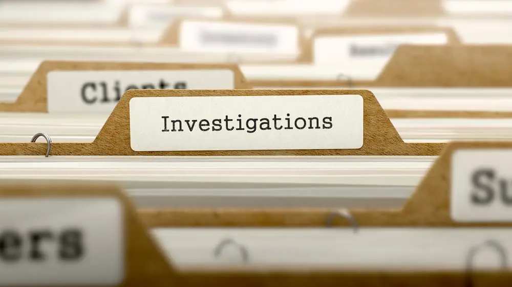 File folder labeled investigations in an office filing system. File folder labeled investigations in an office filing system.