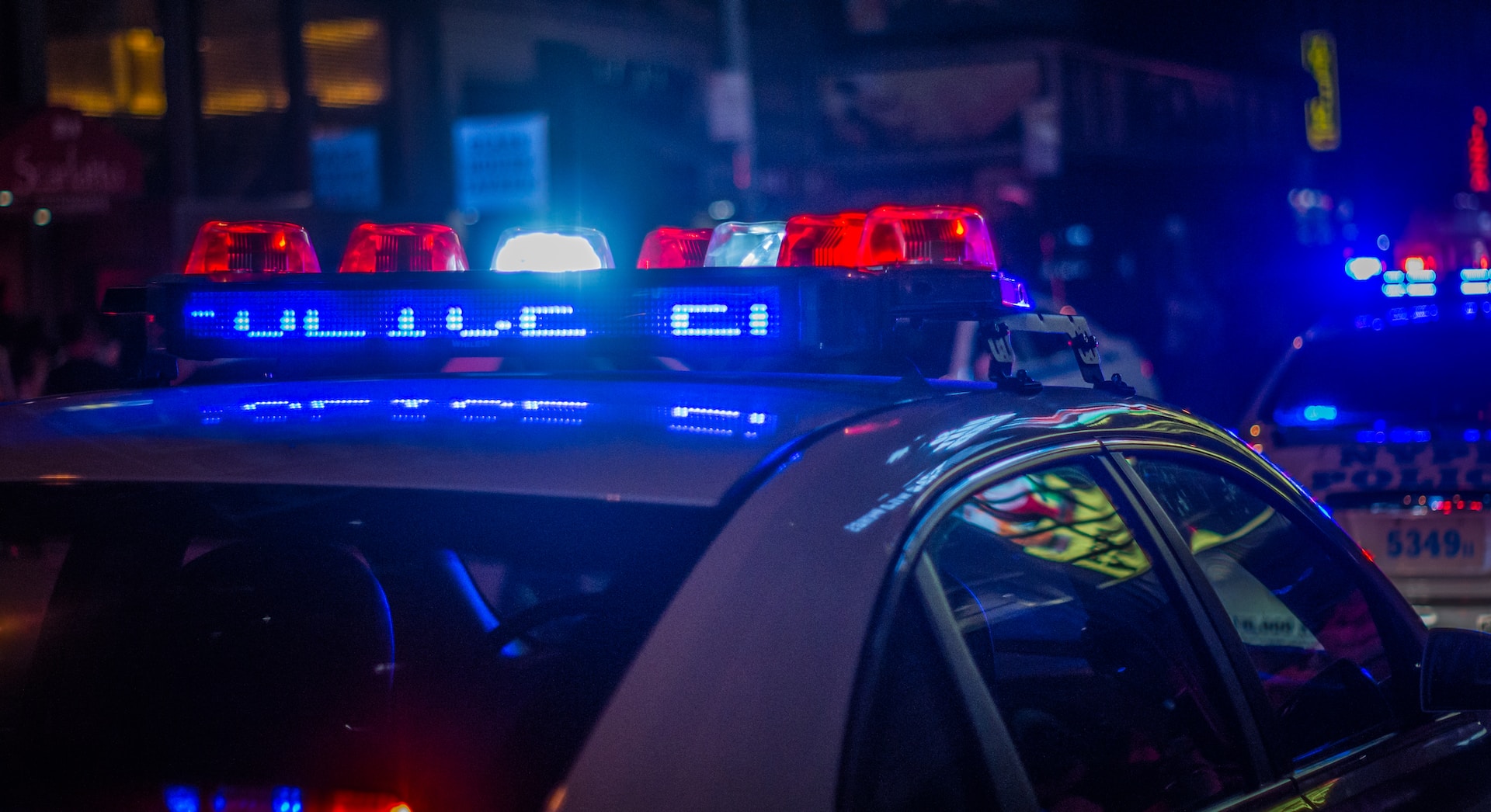 Police car with lights on at night