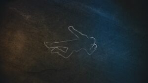 op Down Shot of a Chalk Body Outline on the Pavement Symbolizing a Crime Scene Done on a Street at Night. 